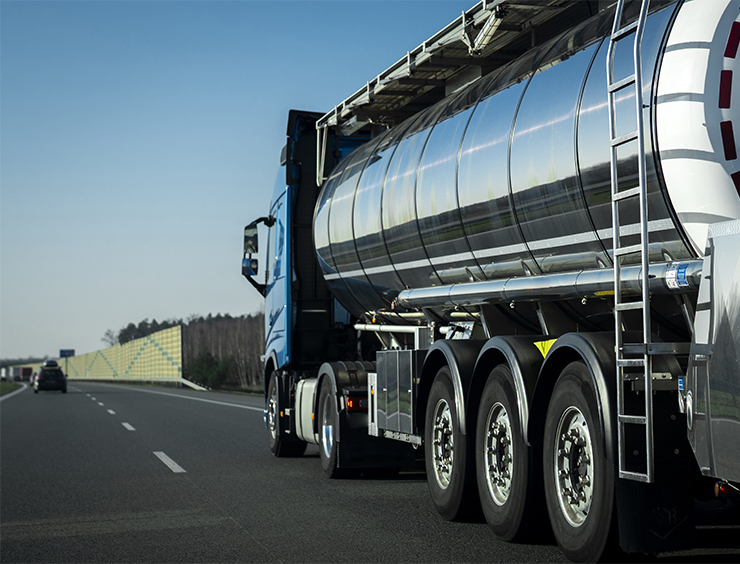 Long vehicle truck with tank trailer on a highway.